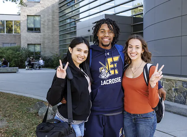 Four students from the 2024 Fresh Faces cohort sit outside on a picnic blanket.