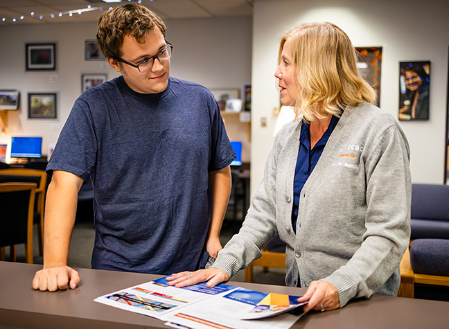 Staff member helping a student