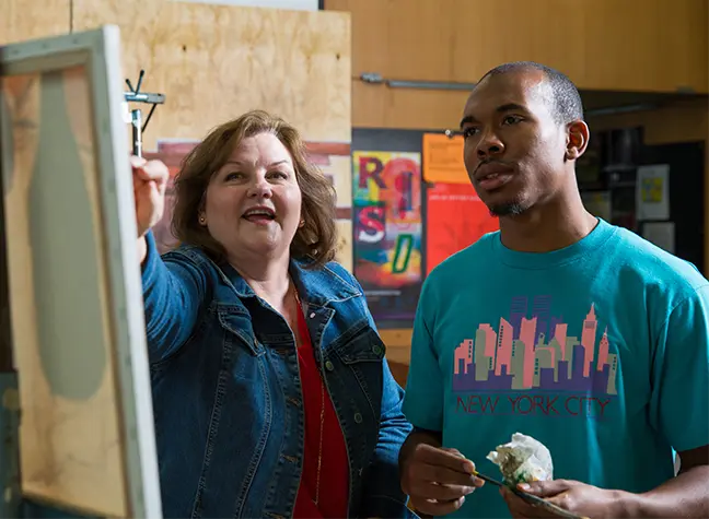 Student painting in art studio